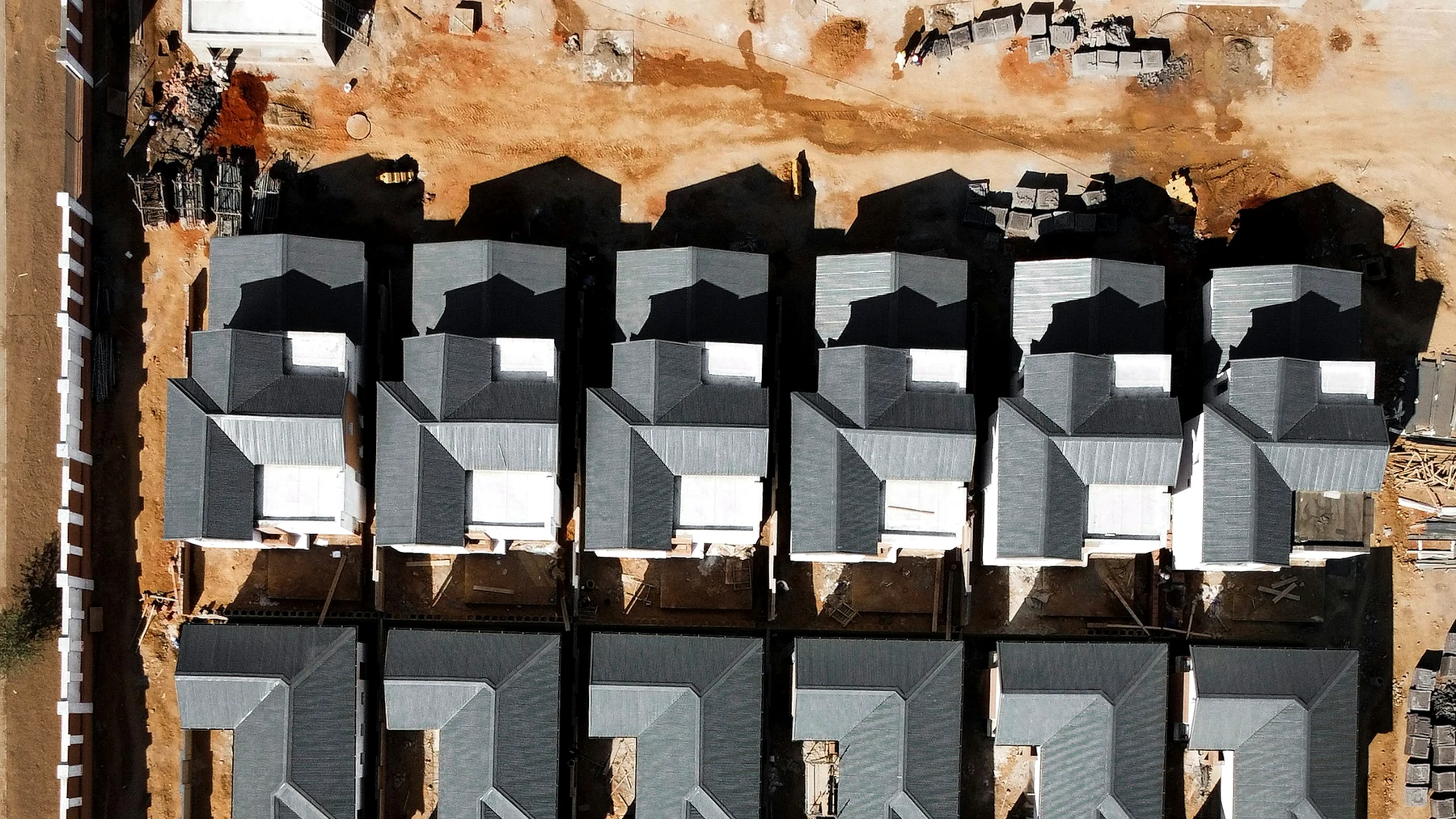 Modern low-rise residential estate construction site with multiple homes