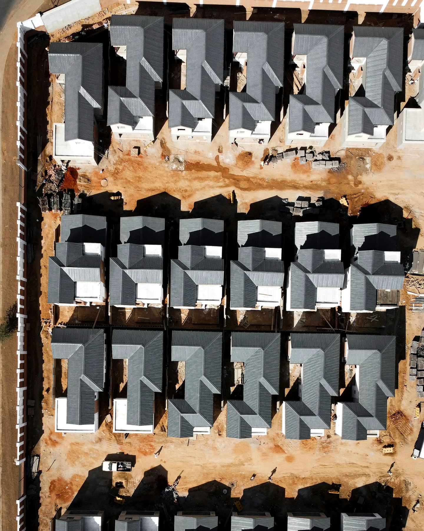 Aerial view of multiple low-rise homes under construction in a residential estate